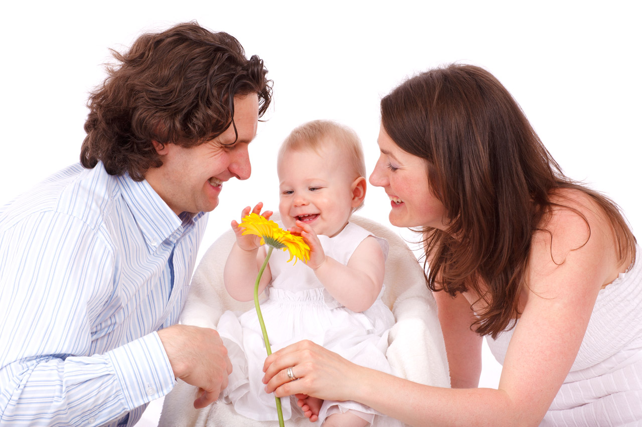 Mom and Dad with Baby holding flower